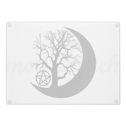 Decorative glass chopping board with a tree silhouette inside a crescent moon and pentacle symbol on a white background.   Perfect for witches and wiccans
