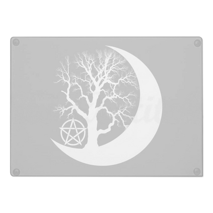 Decorative glass chopping board with a tree silhouette inside a crescent moon and pentacle symbol on a black background.   Perfect for witches and wiccans
