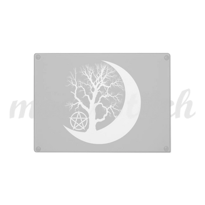 Beautiful glass cutting board with a tree silhouette inside a crescent moon on a black background.  Perfect for witches and wiccans